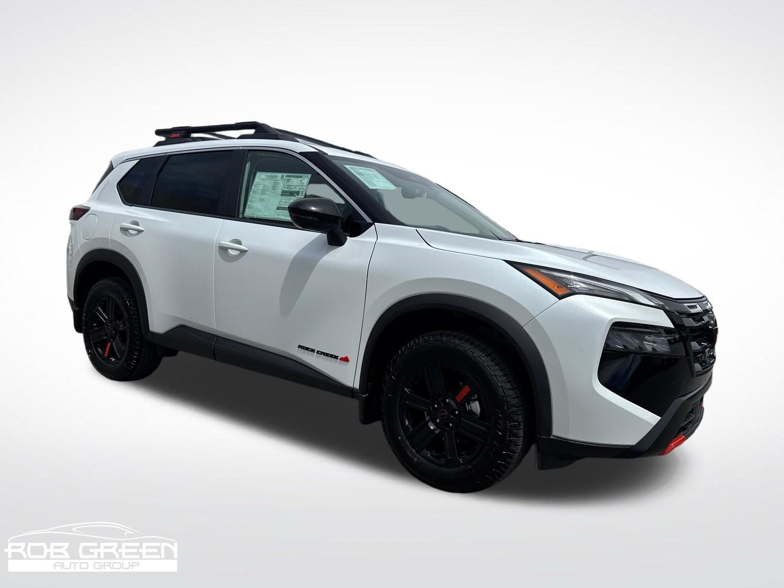 2026 Nissan Rogue Rock Creek in Everest White Pearl Tricoat — front three-quarter view